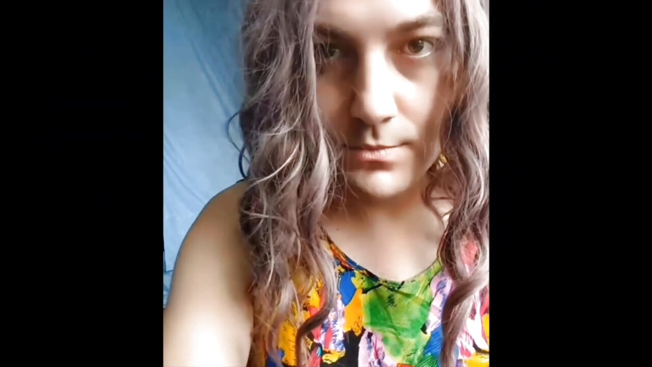 Stunning trans beauty holding tea in cozy kitchen