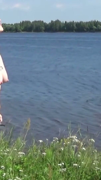 Beautiful naked walk in the wild: Naturist posing in a green spring field | Clip 1