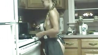 Slutty chick pokes her cunt with kitchen utensils on counter