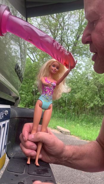 Barbie doll making sissy suck a dildo