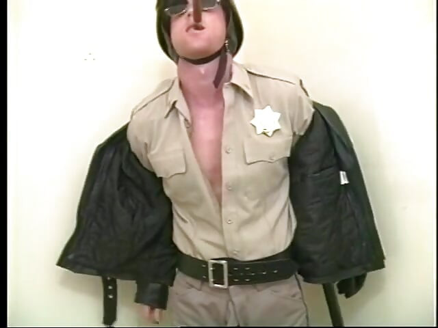Muscular homo stud in police uniform rubs his cock