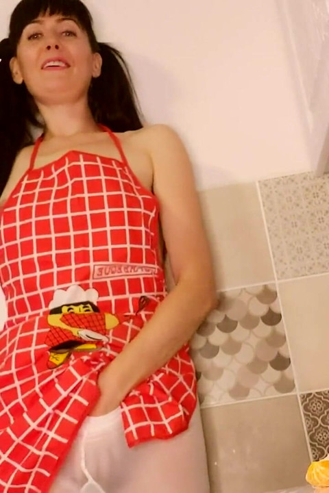 Hot housewife sexually rustles her apron in the kitchen