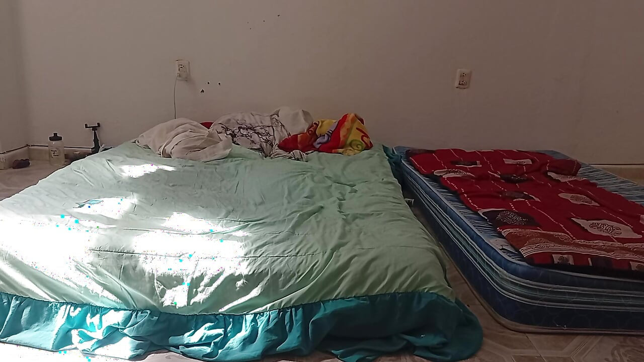 Mexican mother-in-law cleaning guest room in thong