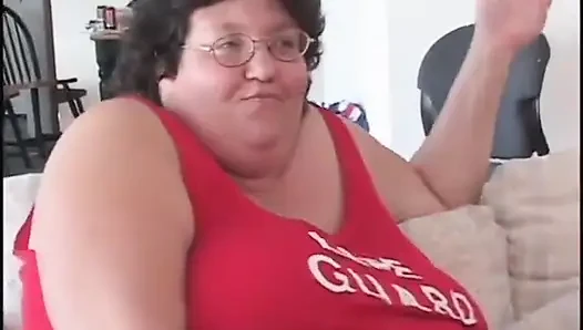 Fat bellied chick in red uniform rides one long stick