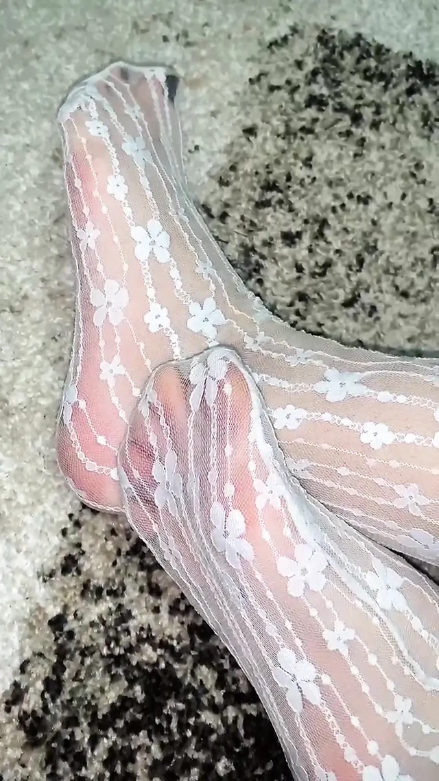 Massaging feet in sexy socks with hands in gloves