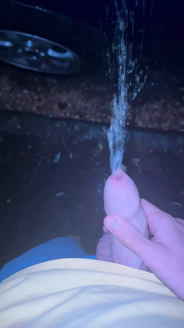 Peeing on a car at night