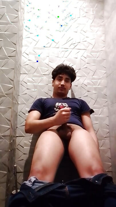 Indian Handsome Boy While His Hard Penis Is Erect and He Strokes His Hand Again in the Toilet Video
