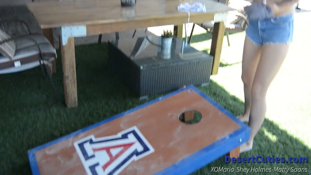 Shey Holmes and two other teens play naked cornhole