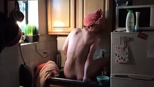 Nude woman bathes in the sink - washing pussy?