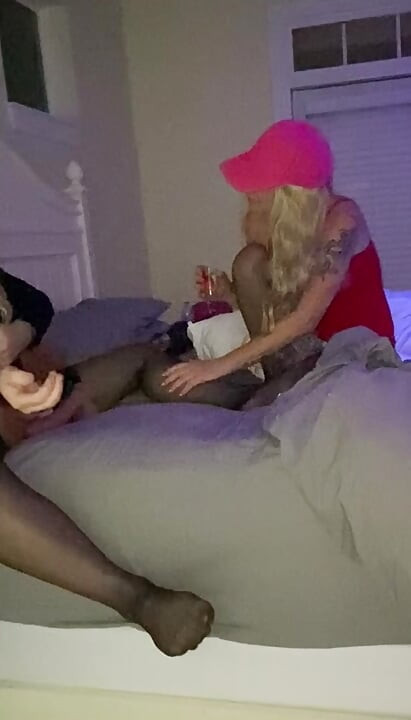 Hotwife and crossdressing hubby in bed in lingerie, stockings and  the wife is telling  Crossdresser a story about fucking