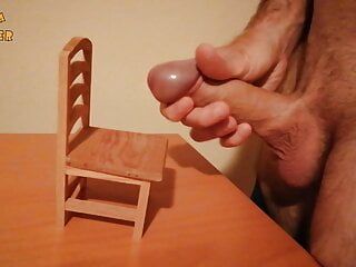 Handjob and cumshot on a small wooden chair