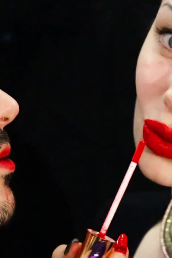 Covering Alex face with red lipsticks kisses