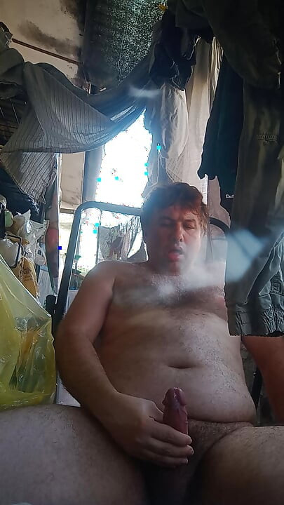 Guy jerks off on the deckchair cumming and evaluating his cum