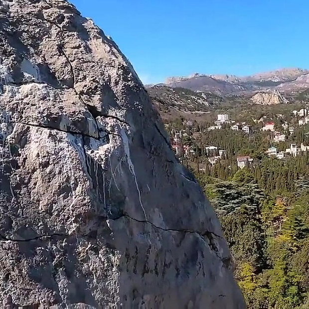 Outdoor Erotica, a Girl with a Stunning Figure Shows Her Magnificent Ass Against the Backdrop of the Sea and Mountains.