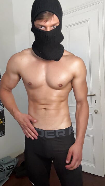 Masked hunk showing off his muscles