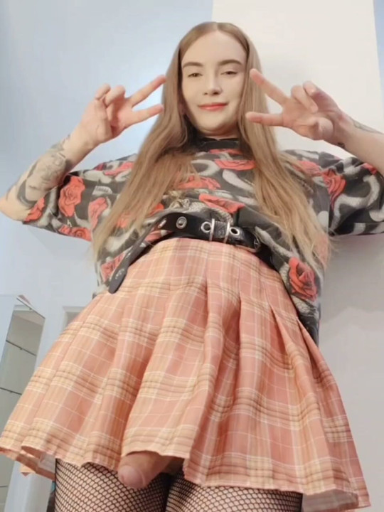 A ginger shemale's cock is bouncing under her skirt