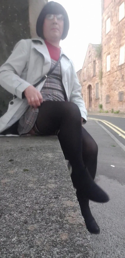 Stunning moment from "Crossdressing slut exposes her caged cock on public street"