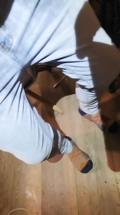 Desperately trying to hold but letting it all out in female light wash jeans