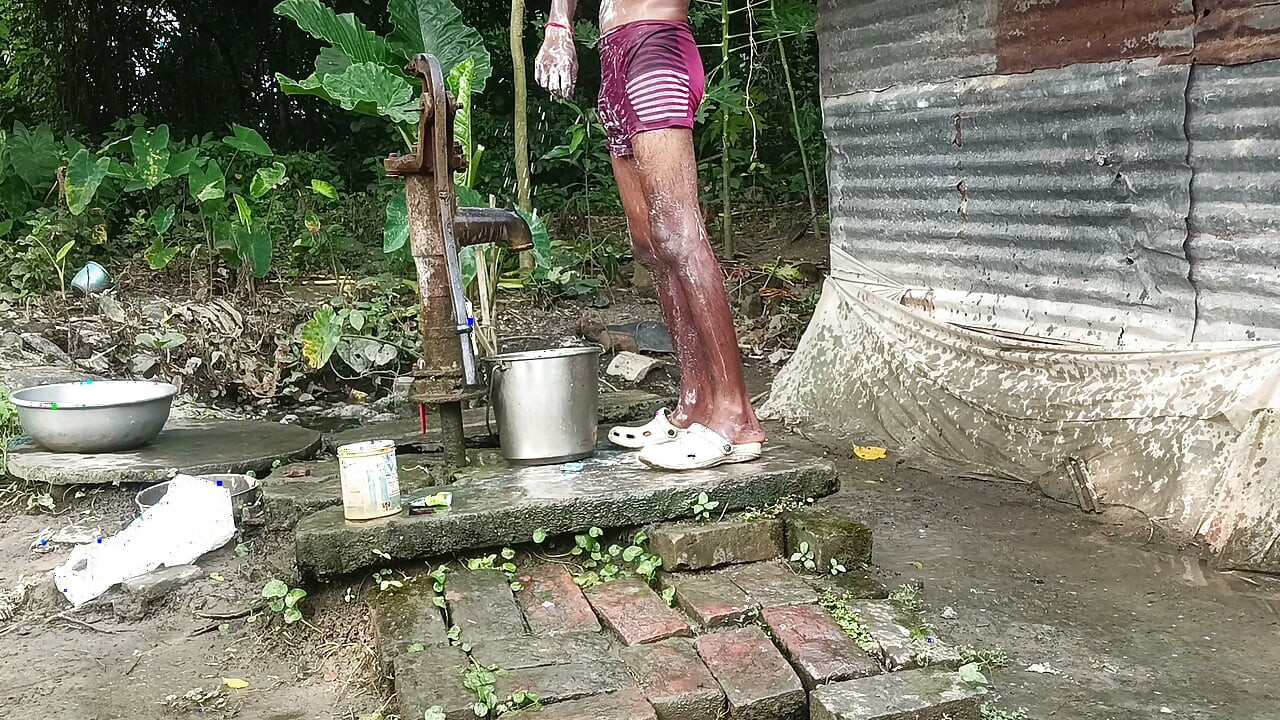 Black mature man bath in desi style. Showing big dick.