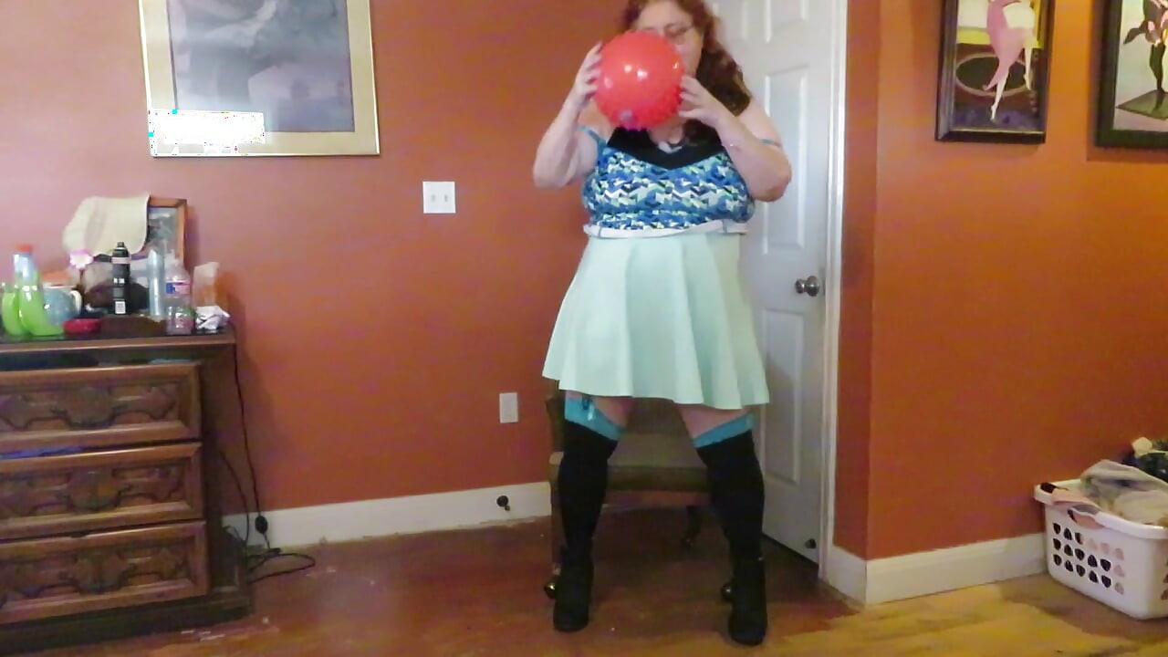 Nurse Vicki  plays with a rubber ball in a mini skirt, sexy stockings and high heel mini boots