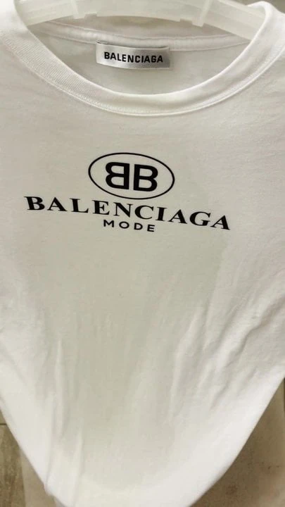 Finishing pissing on her Balenciaga t-shirt