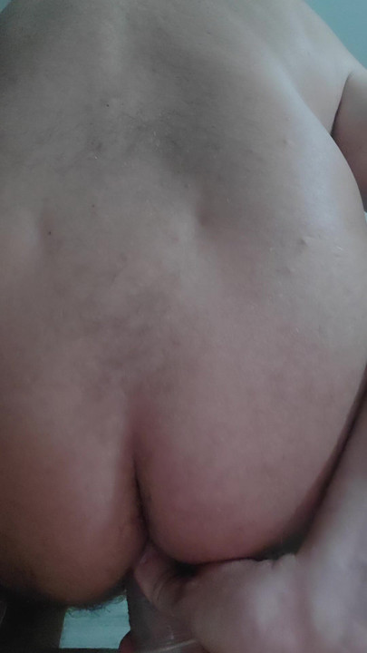 The slave sticks a big dildo in his hole