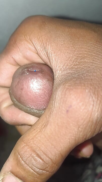Young boy massages his big penis in a closed room