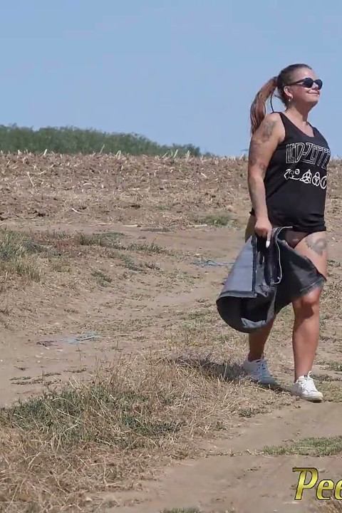 Pee standing on a dirt road in the countryside