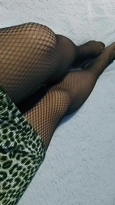 Fishnet pantyhose over sheer nylons tease