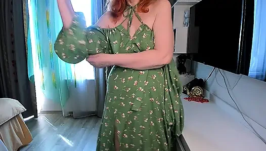 Hot redhead girl slowly undresses  Green floral dress, open back, high slit, stockings and red shoes
