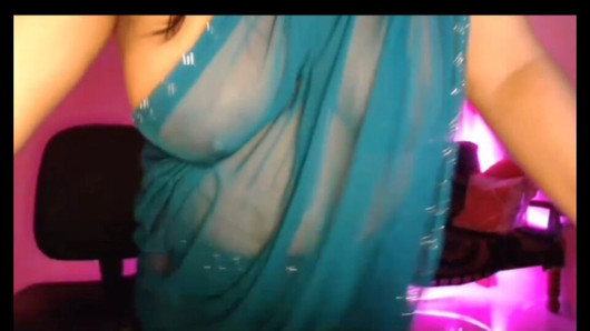 Bhabhi, crazy with the juice of hot youth, is enjoying by opening her bra and showing her boobs through the saree.