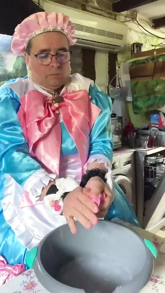 In a blue maid's outfit with pink bows to do the laundry.