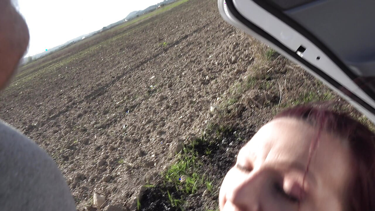Redhead chick sucks big pecker in the car