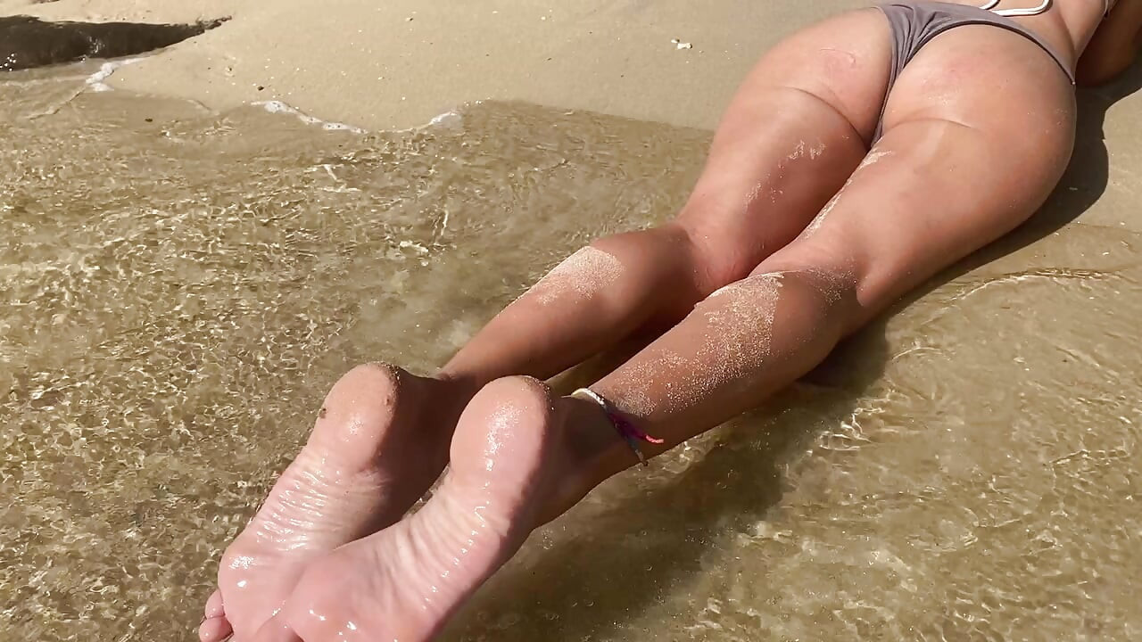 Sexy girl can't control herself on the public beach and masturbates without shame