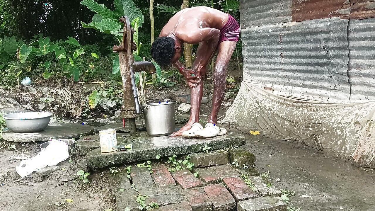 Black mature man bath in desi style. Showing big dick.