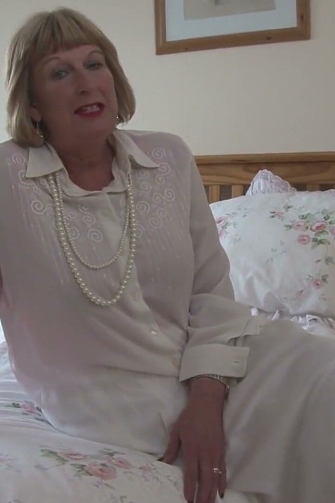 Horny mature fingering pussy in bed