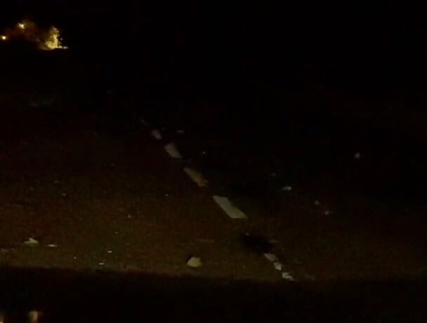 Naked in road and hiding the wrong side of road from safety when car passed