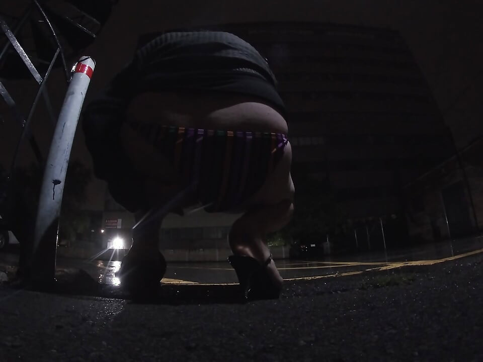 Mature sissy CD out in the rain in A parking lot in public masturbation.