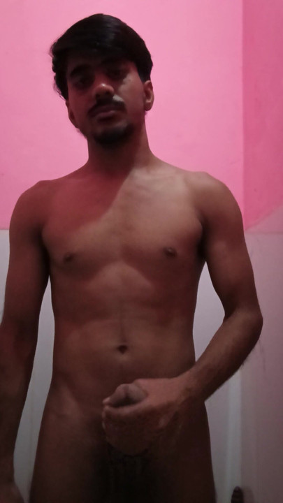 Guy is shaking his cock in the bathroom