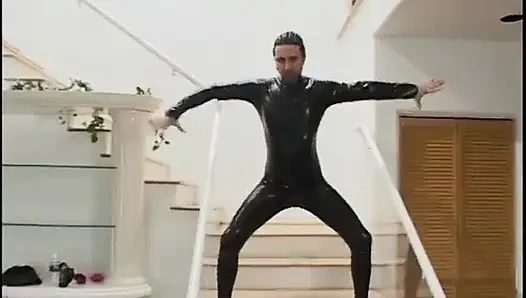 Two guys wearing masks get their large cocks sucked by a hot chick in latex gear