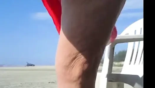 Hot crown sunbathing on the beach in transparent micro bikini