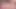A naked woman with a joyful expression in orgasm on the bed