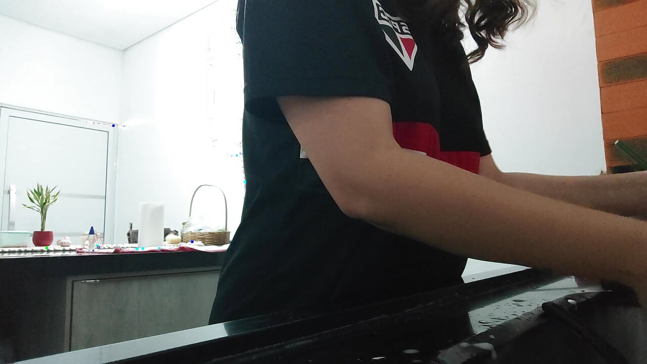 Woman teasing while washing dishes. She loves to transmit to the voyeurs on duty