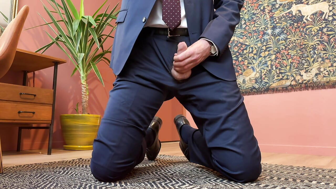 Jerking off at the office in a suit and tie