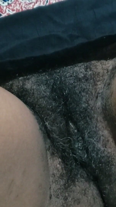 Seductress show you her hairy pussy side of mature in a dimly lit room filled with sultry shadows | Clip 1