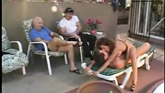 Busty brunette sucks cock while getting fucked on lounge chair