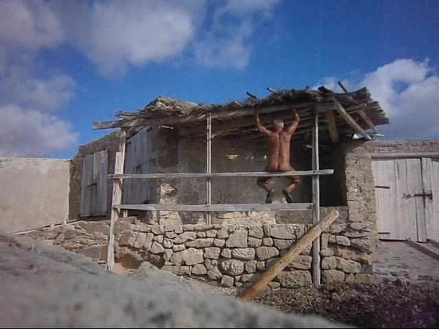 naked man at a fishing hut