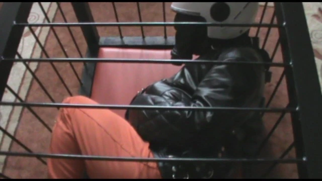 Straitjacketed prisoner in the cage