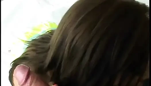 Brunette whore is on her knees stuffing two cocks in her mouth