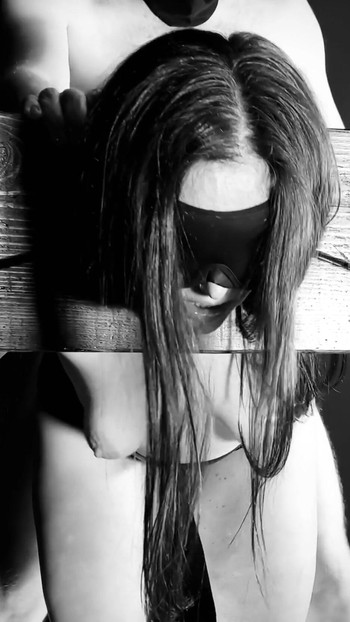 Stunning moment from "Topless Blindfolded Brunette Sex slave in stocks sucks cock and gets fucked"